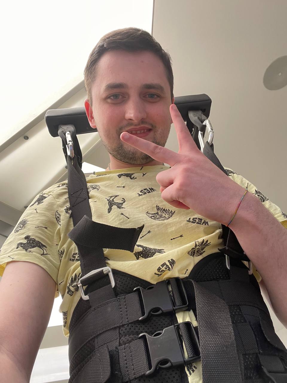 Igor on rehabilitation equipment showing peace sign